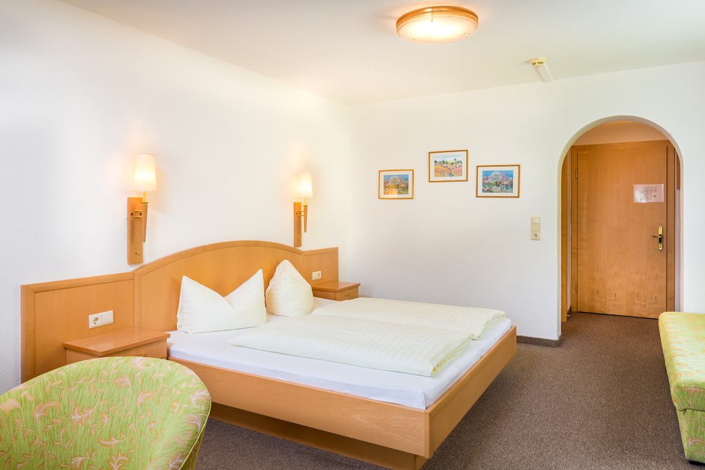 Bright double room in Hotel Grissemann Flirsch am Arlberg with cozy flair and mountain view