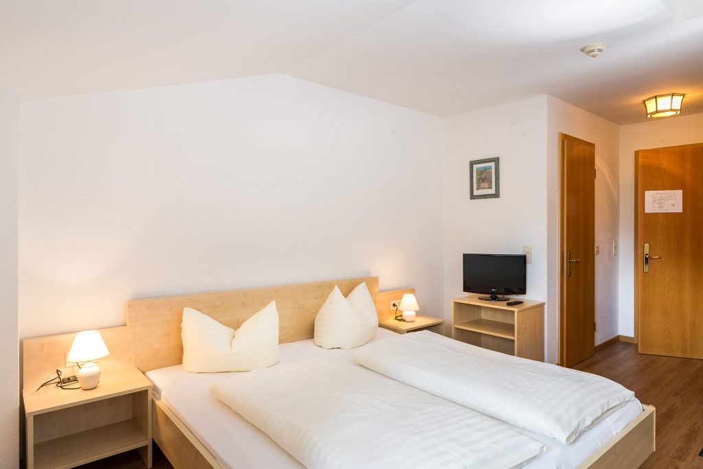 Bright double room in Hotel Grissemann in Flirsch am Arlberg with TV and cozy atmosphere